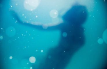 Photo of a woman under water by Nsey Benajah on Unsplash