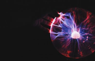 A photo of human hand holding plasma ball by Ramon Salinero on Unsplash